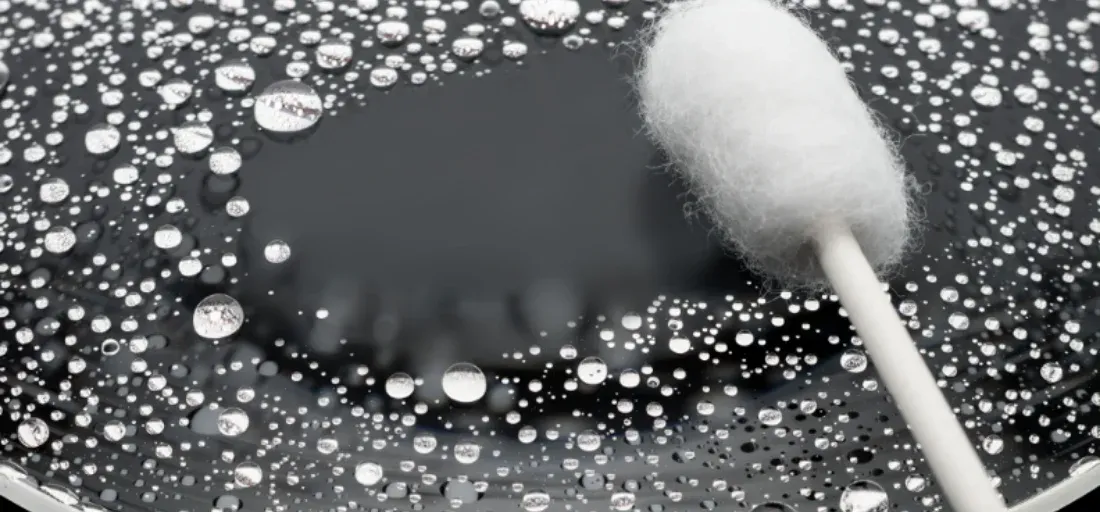 Photo on the lens glass showing how water beads up on the glass making it easy to clean with in the field.