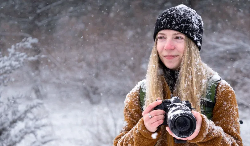 Photographer Tiffany Taxis in a snowy field.